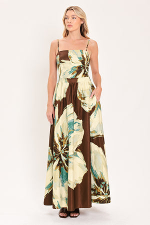 A woman modeling a sleeveless top and  matching maxi skirt with a brown and cream floral print and teal accents | Flying Tomato
