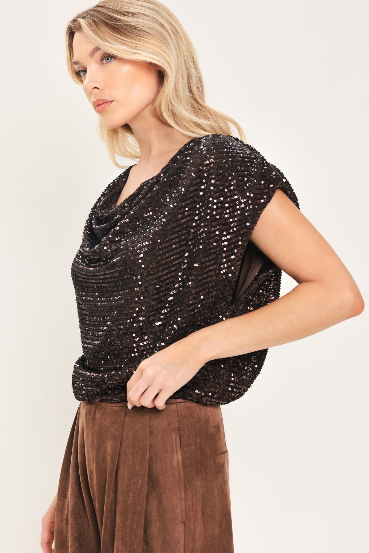 Woman wearing a cropped dark brown sequins top with a cowl neckline and overall slouchy look | Flying Tomato