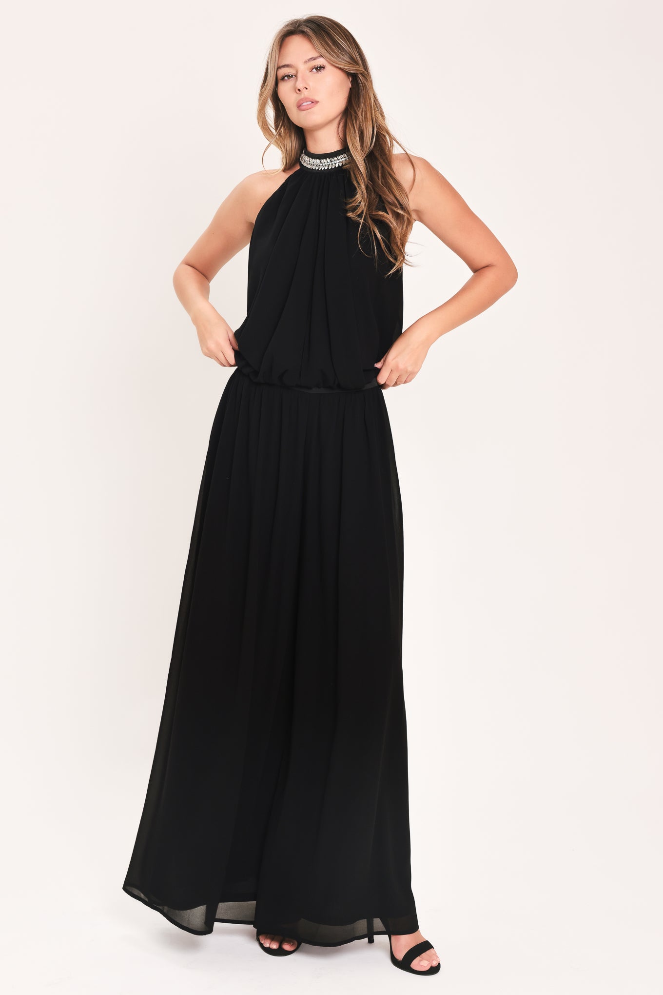 A woman modeling a sleeveless black halter top and wide leg pant set with a beaded choker neckline | Flying Tomato