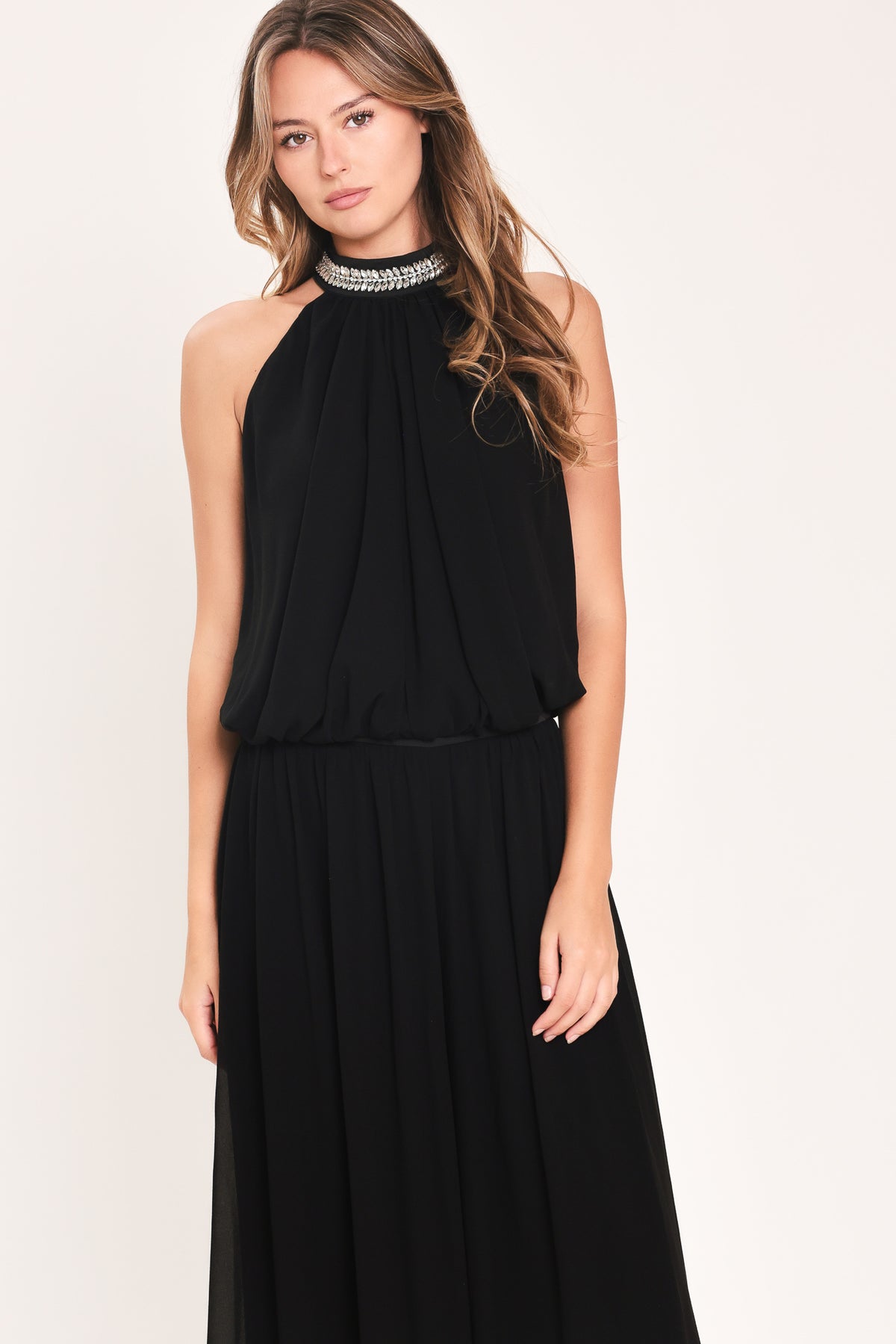A woman modeling a sleeveless black halter top and wide leg pant set with a beaded choker neckline | Flying Tomato