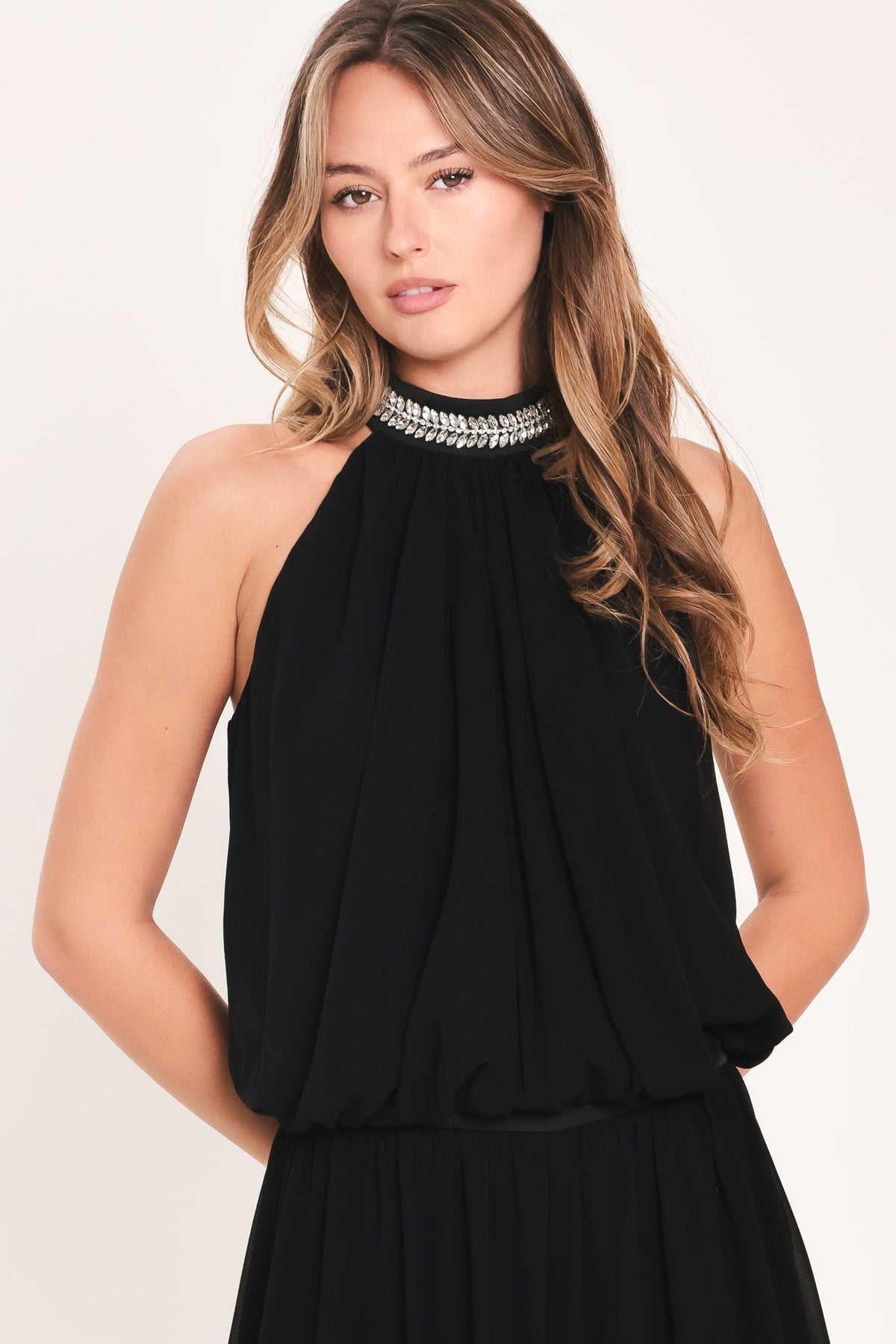 A woman modeling a sleeveless black halter top and wide leg pant set with a beaded choker neckline | Flying Tomato