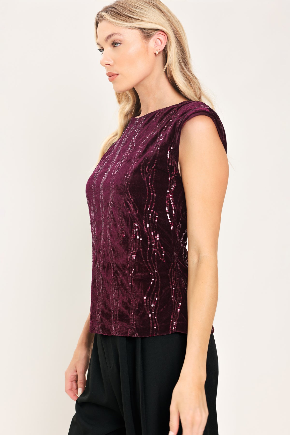 A woman modeling a sleeveless deep burgundy sequined top paired | Flying Tomato