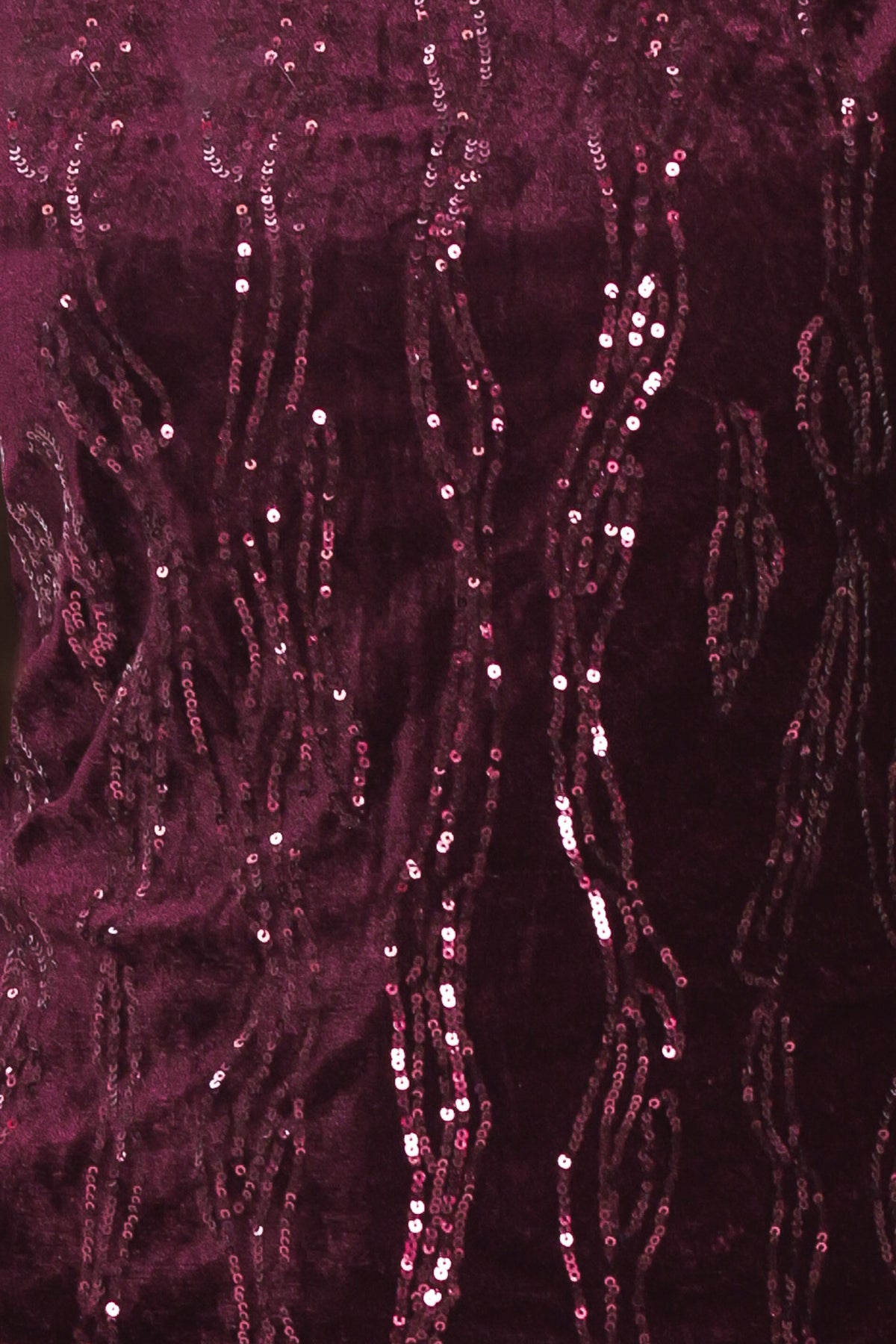 A woman modeling a sleeveless deep burgundy sequined top paired | Flying Tomato