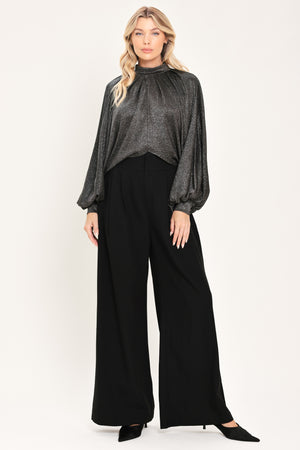 A woman modeling a dark gray metallic high-neck blouse with voluminous balloon sleeves | Flying Tomato