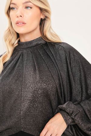 A woman modeling a dark gray metallic high-neck blouse with voluminous balloon sleeves | Flying Tomato
