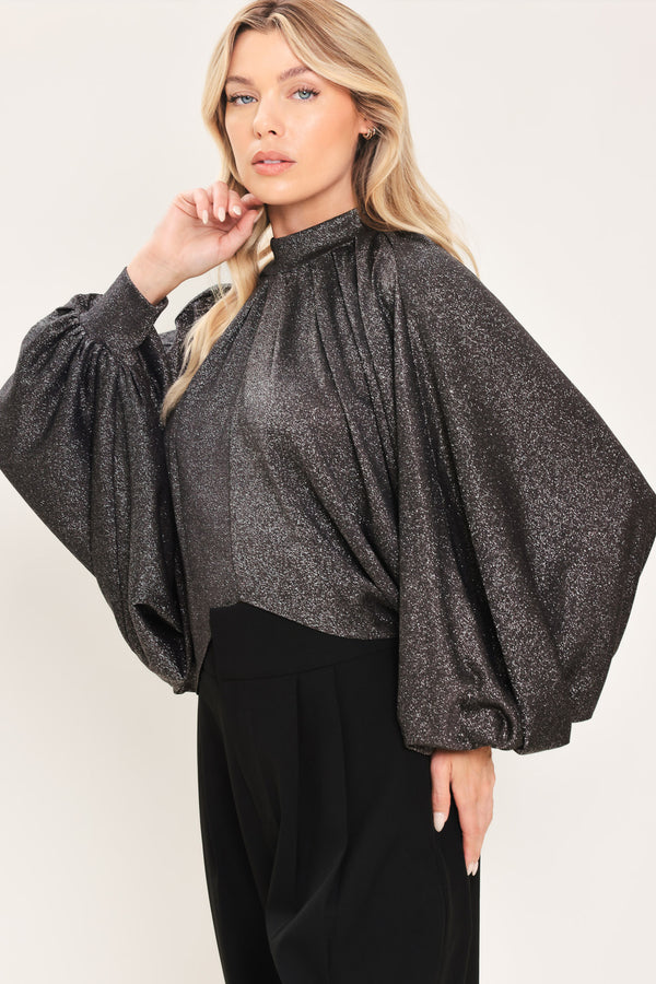 A woman modeling a dark gray metallic high-neck blouse with voluminous balloon sleeves | Flying Tomato