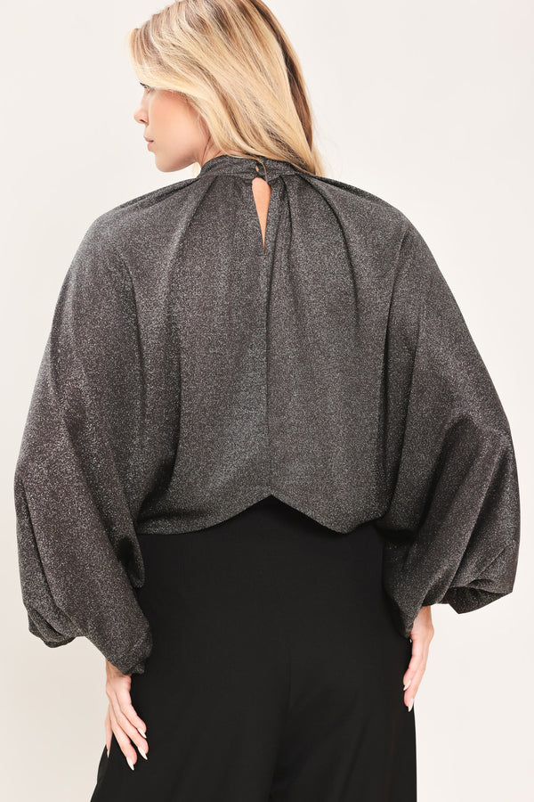 A woman modeling a dark gray metallic high-neck blouse with voluminous balloon sleeves | Flying Tomato