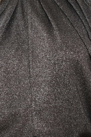 A woman modeling a dark gray metallic high-neck blouse with voluminous balloon sleeves | Flying Tomato