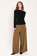 Woman wearing a long sleeve asymmetrical neck black top | Flying Tomato