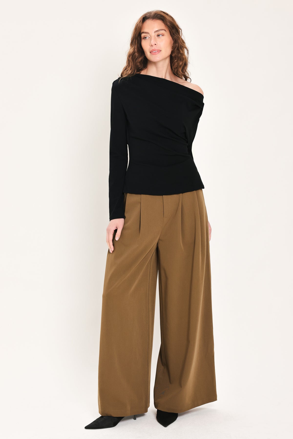 Woman wearing a long sleeve asymmetrical neck black top | Flying Tomato