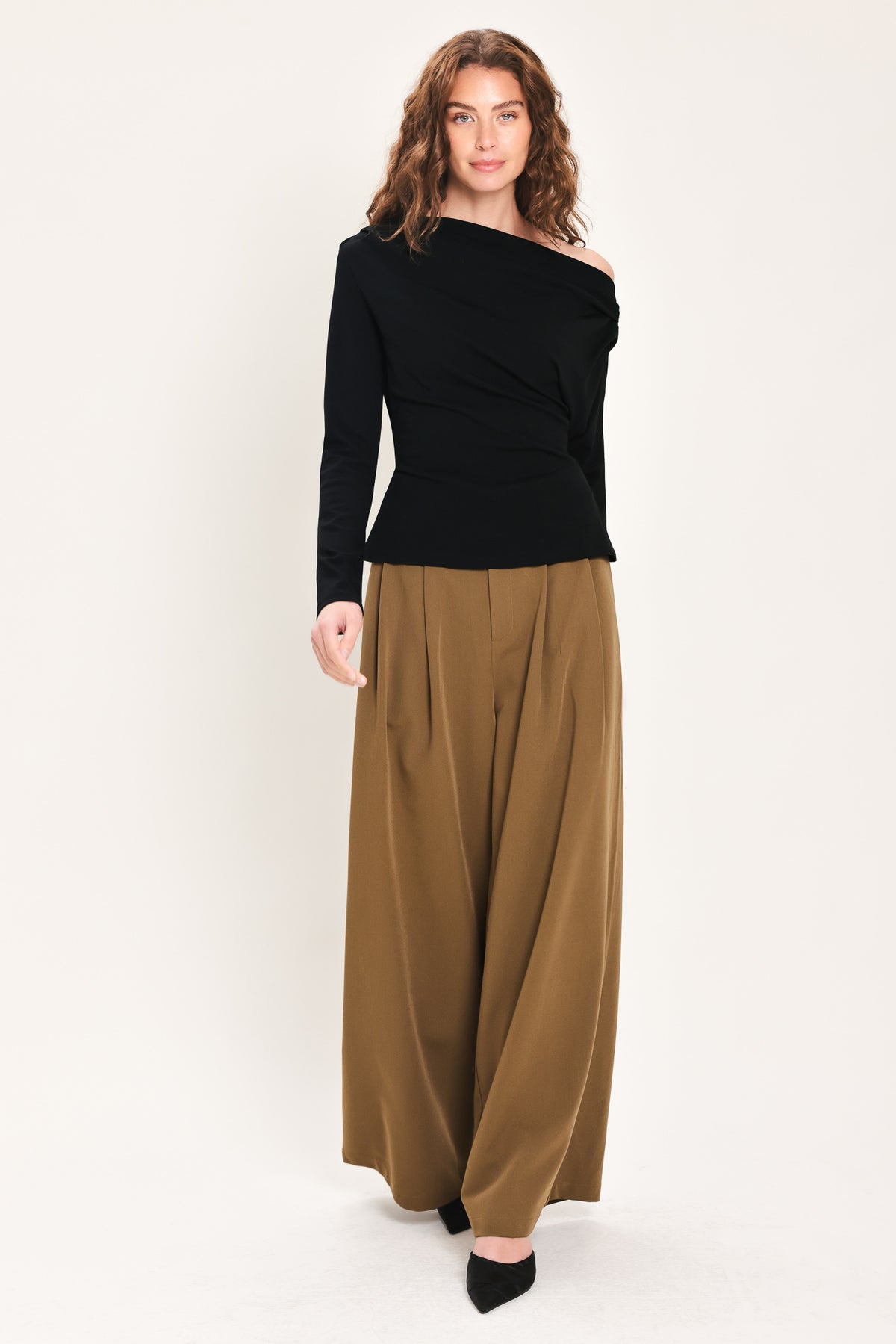 Woman wearing a long sleeve asymmetrical neck black top | Flying Tomato
