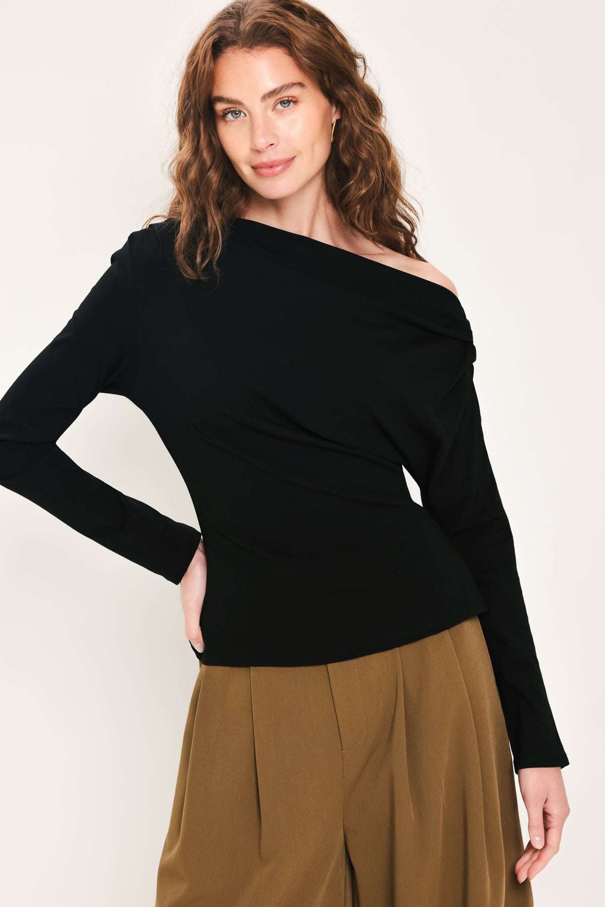 Woman wearing a long sleeve asymmetrical neck black top | Flying Tomato