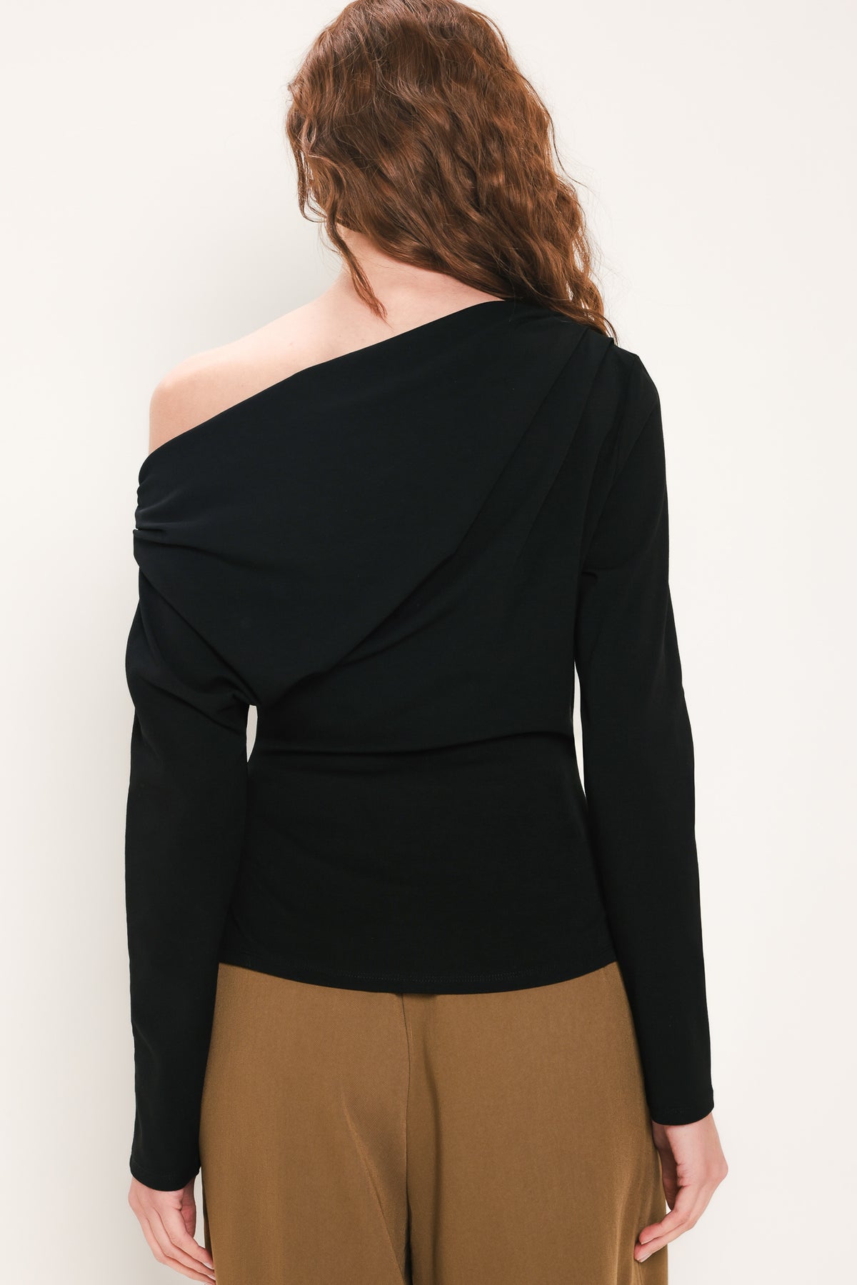Woman wearing a long sleeve asymmetrical neck black top | Flying Tomato