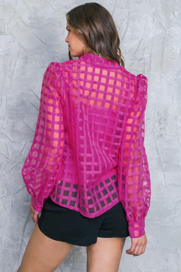 FLUTTERING ON WOVEN TOP.