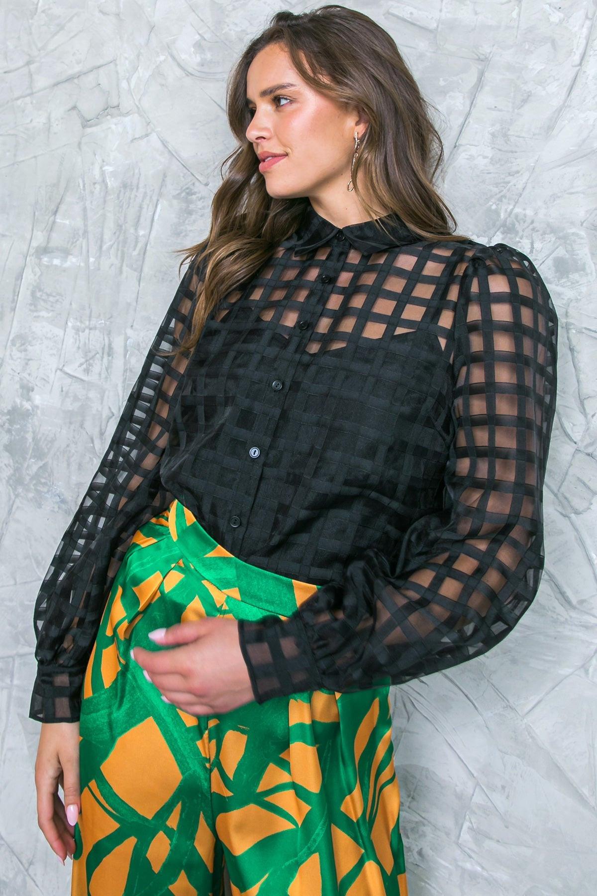 FLUTTERING ON WOVEN TOP.