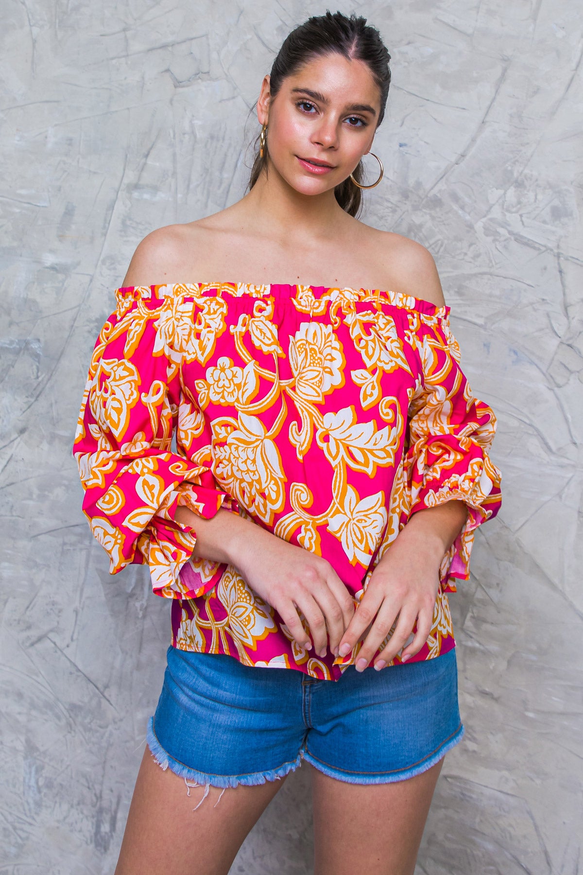  This MEANT TO SHINE POPLIN TOP is a stylish choice for any wardrobe. Its off-shoulder neckline and ruffled edge provide a fashion-forward look, while its long sleeves and ruffled cuffs offer an on-trend aesthetic. The relaxed body allows for ultimate comfort, making it ideal for any occasion.