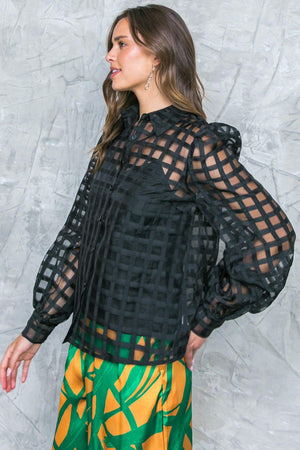 FLUTTERING ON WOVEN TOP.