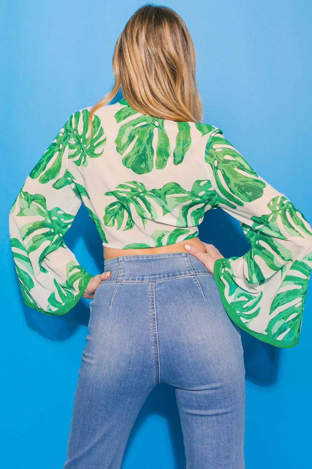 Green leaf-patterned shirt on a white background