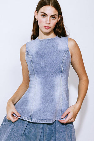 Experience exquisite style with our washed denim top, boasting a round neckline, sleeveless design, and back button down/tie closure.