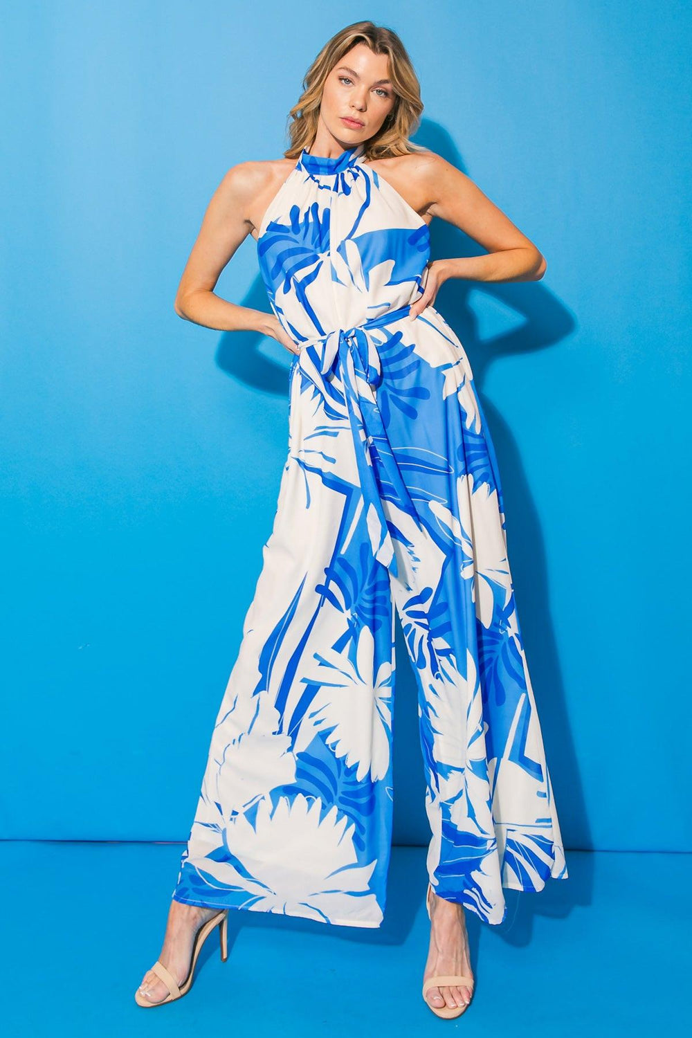 Blue and white floral patterned jumpsuit on a white background